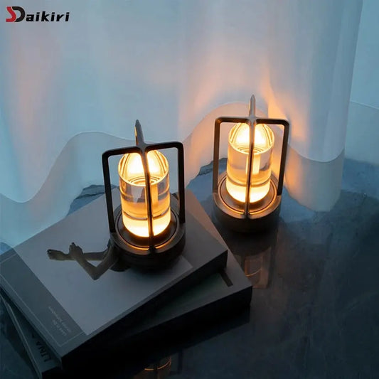 Two lit lanterns on a surface with a blurred background