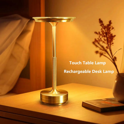Gold touch table lamp on a bedside table with warm lighting