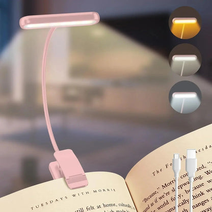Pink booklight on an open book with three light mode indicators in the corner.