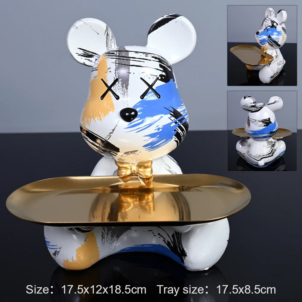 Decorative figurine with a gold base on a dark surface