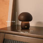 Mushroom-shaped lamp on a wooden surface with measurements indicated