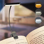 Clip-on book light on an open book with three color options displayed.
