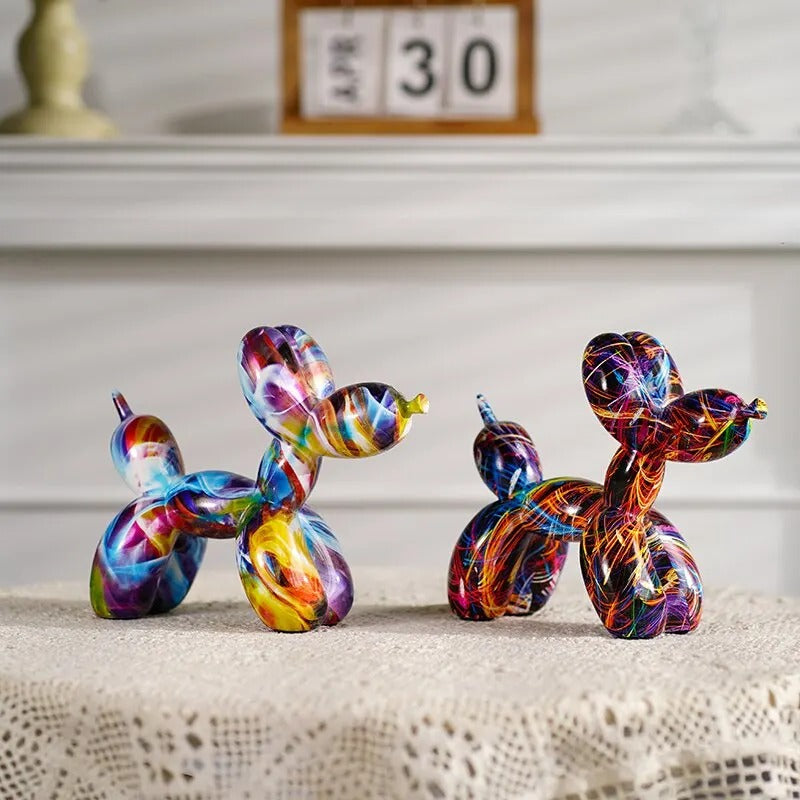 Colorful glass dog sculptures on a textured surface with a calendar in the background