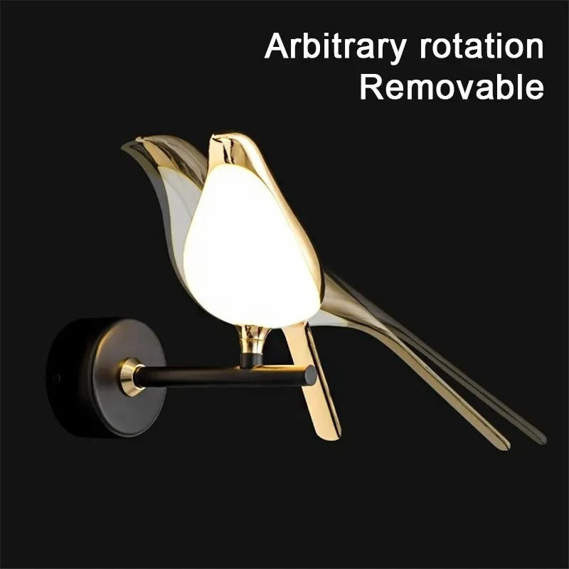 Modern wall light fixture with gold and black design on a black background
