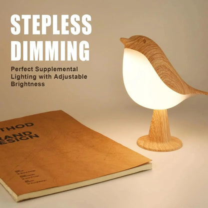 Wooden bird-shaped lamp with stepless dimming feature on a surface next to a book.
