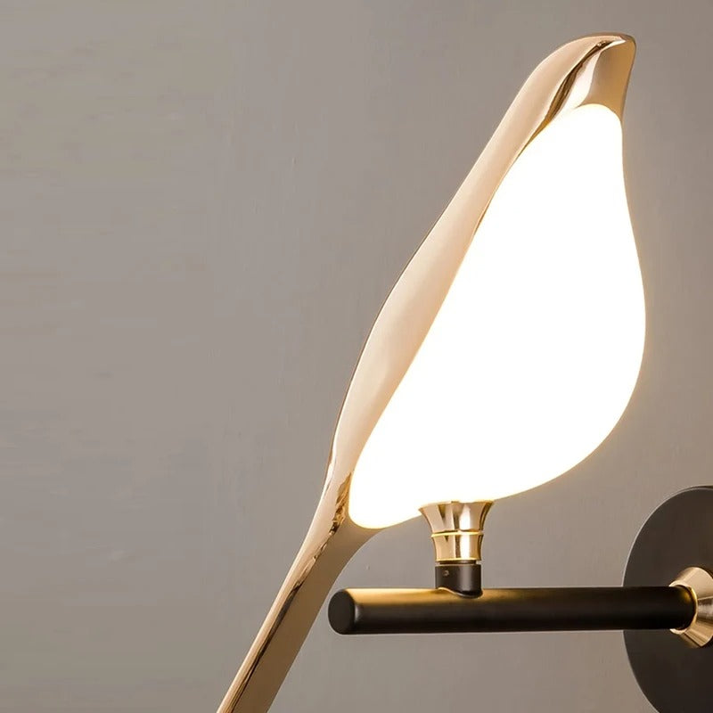 Modern wall lamp with gold and black design on a gray background