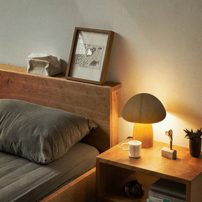 Nestled corner of a room with wooden bed, side table, and lamp.