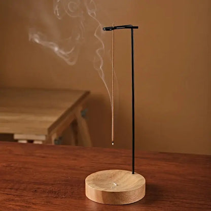 Incense burner with smoke on a wooden surface
