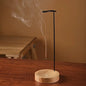 Incense burner with smoke on a wooden surface