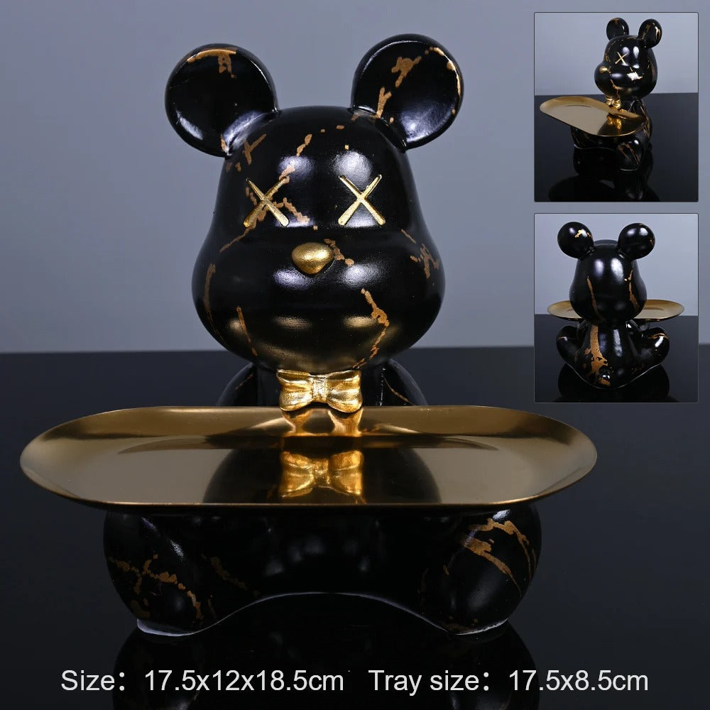 Black bear-shaped tray with gold accents on a reflective surface
