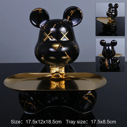 Black bear-shaped tray with gold accents on a reflective surface