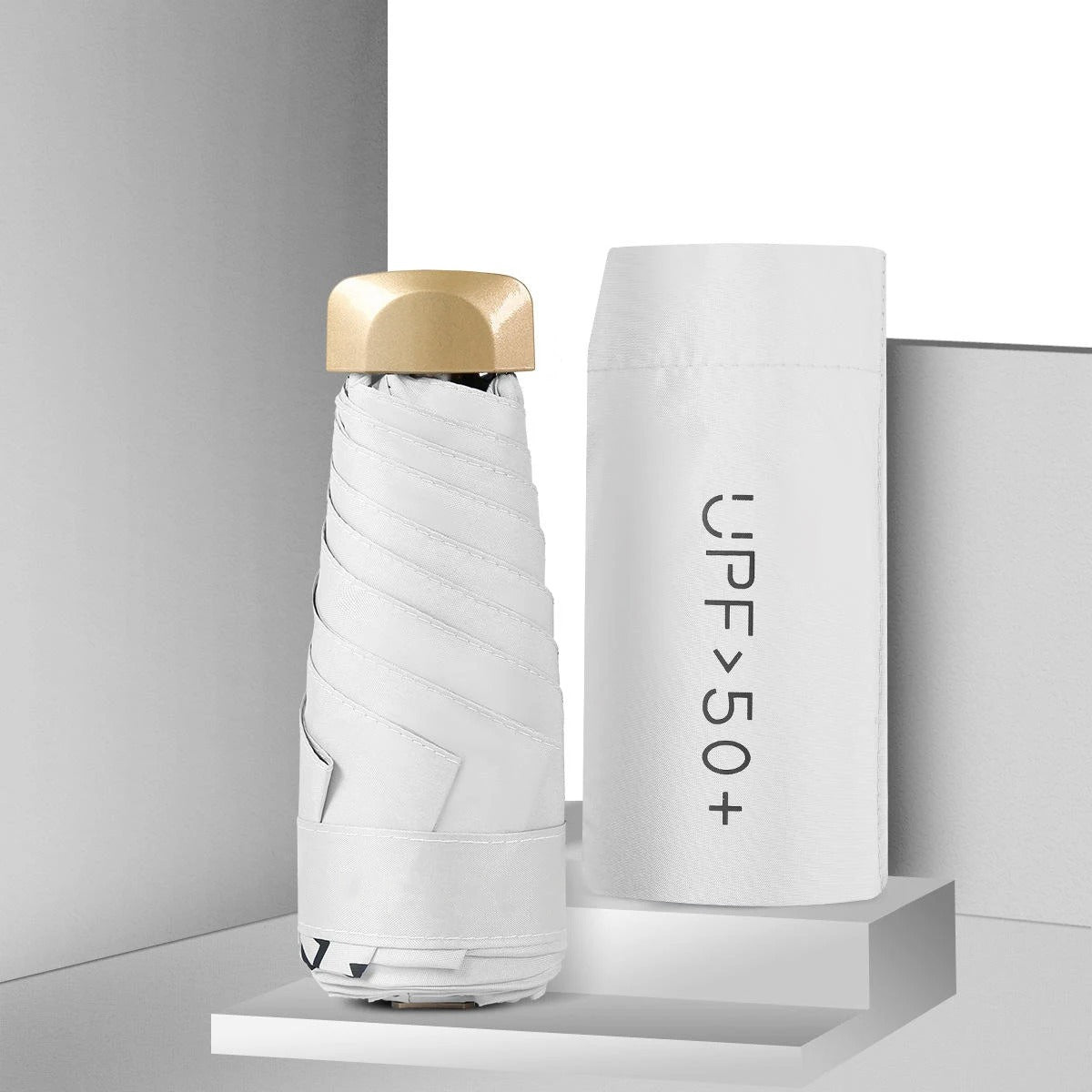 White umbrella with gold top on a gray background