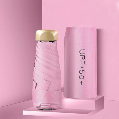 Pink umbrella with gold top on a pink background